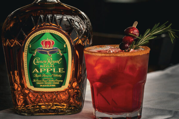 Crown Royal Apple Whisky, 
cranberry juice & ginger beer. Served with a cinnamon
sugar rim, fresh cranberries and sprig of rosemary.