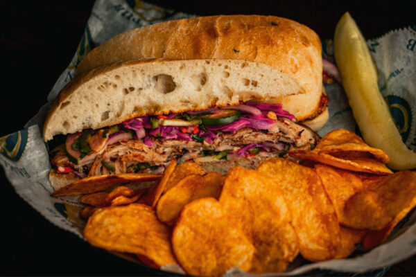 ender grilled pork-belly served on a soft Ciabatta roll. Topped with an Asian fusion of mixed vegetables garlic aioli sauce. Served with homemade pub chips. 