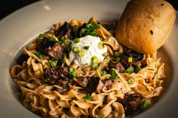 Tender pieces of oven roasted beef sautéed mushrooms in a rich cream sauce and tossed with egg noodles. Topped with a dollop of sour cream & fresh chopped scallions. 